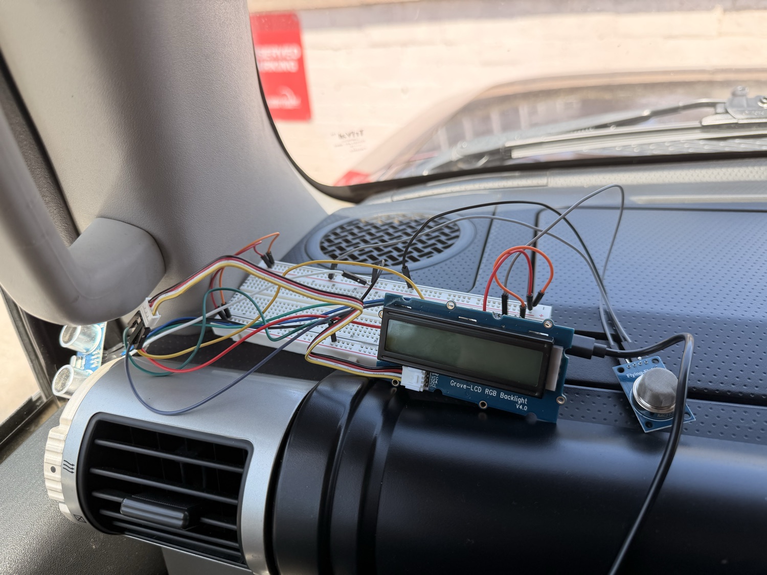 The Invisible Passenger device mounted on the center console of the car
