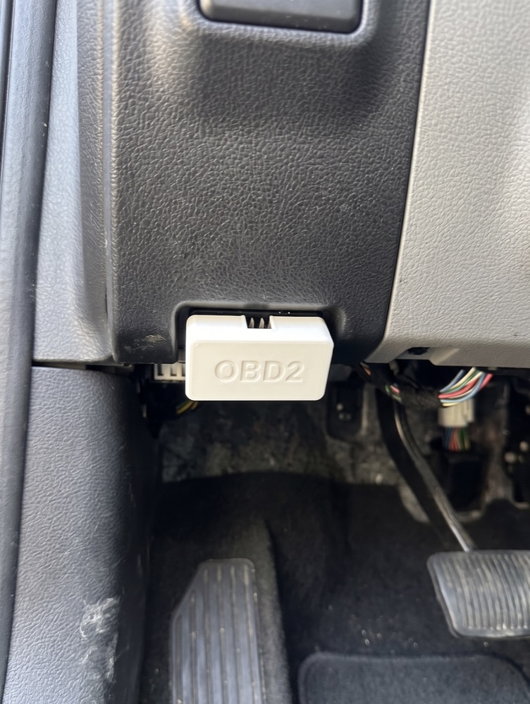 NextFix 3D-printed OBD2 device plugged into a car