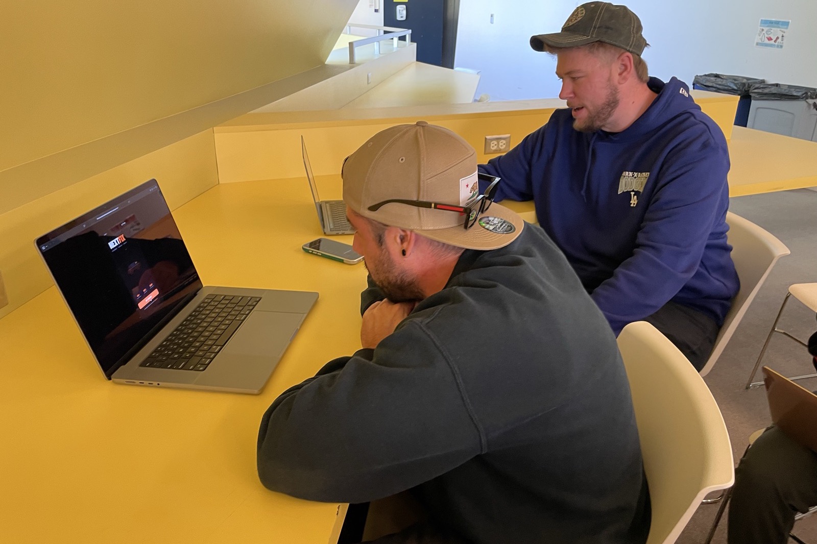 A participant working through the prototype while a teammate takes notes