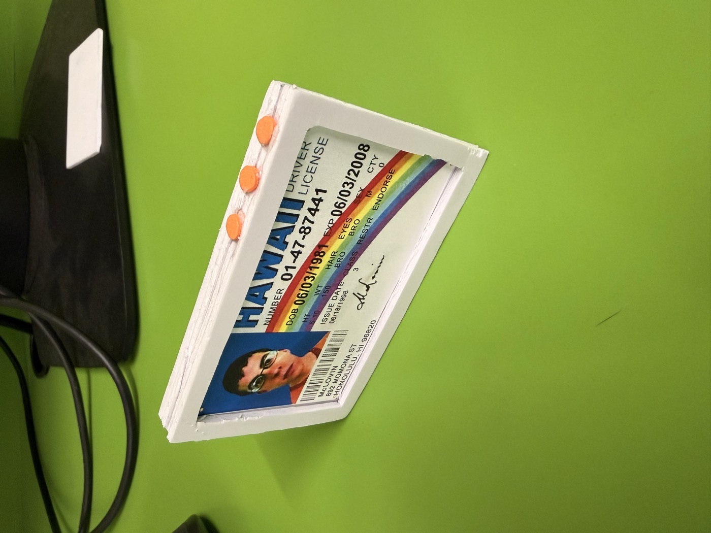 Foamcore prototype of the digital wallet with three orange buttons